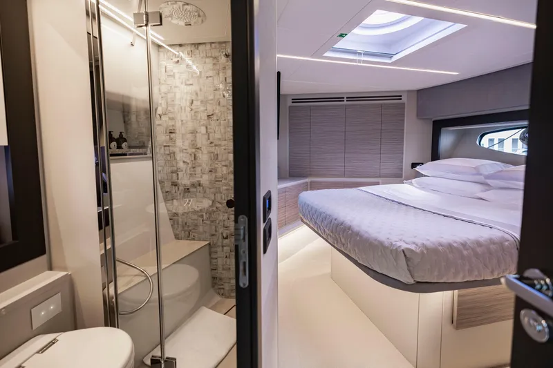 Slide: The Image of Luxurious interior of 2021 Pershing 62 yacht featuring bedroom and modern bathroom. - 101