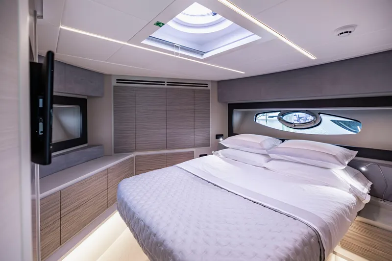 Slide: The Image of Luxurious bedroom interior of 2021 Pershing 62 yacht with modern design and skylight. - 103