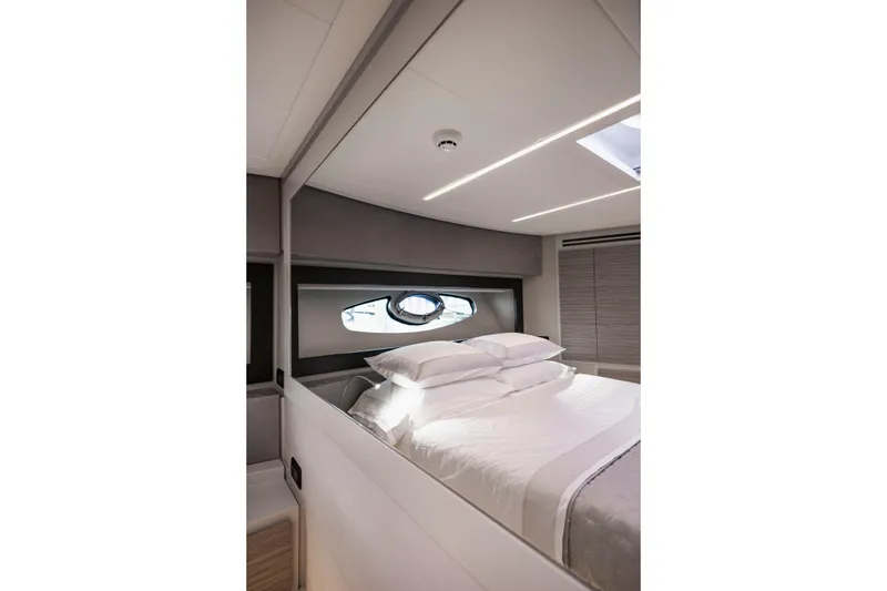Slide: The Image of Luxurious bedroom interior of 2021 Pershing 62 yacht with modern design and elegant bedding. - 104
