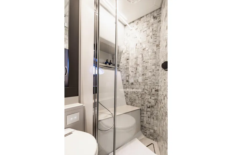 Slide: The Image of Luxurious bathroom in 2021 Pershing 62 yacht with modern shower and elegant tile design. - 108
