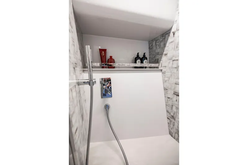 Slide: The Image of Luxury shower area in 2021 Pershing 62 yacht with modern fixtures and toiletries. - 110