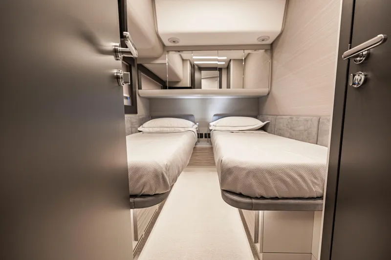 Slide: The Image of Luxurious twin cabin interior of 2021 Pershing 62 yacht, featuring modern design and comfort. - 111