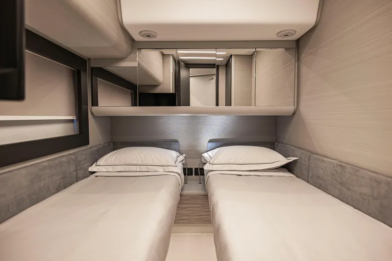 Slide: The Image of Luxurious twin cabin interior of 2021 Pershing 62 yacht, featuring modern design and comfort. - 112