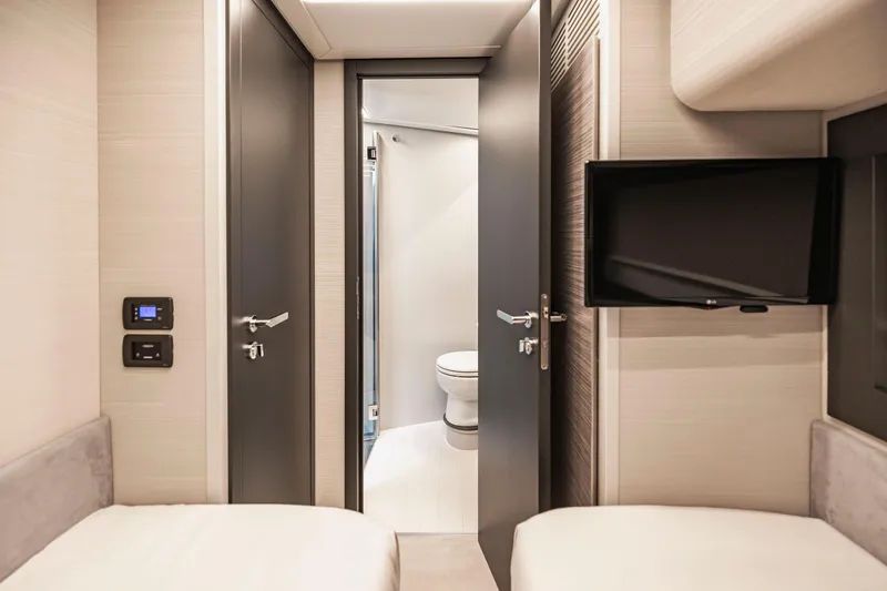 Slide: The Image of Interior of 2021 Pershing 62 yacht cabin with modern bathroom and TV. - 113