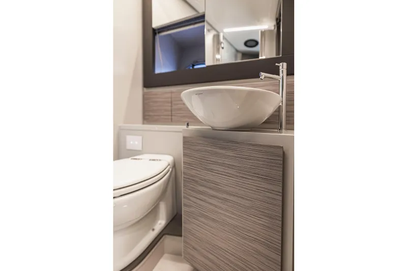 Slide: The Image of Modern bathroom interior on 2021 Pershing 62 yacht, featuring sleek sink and toilet design. - 116