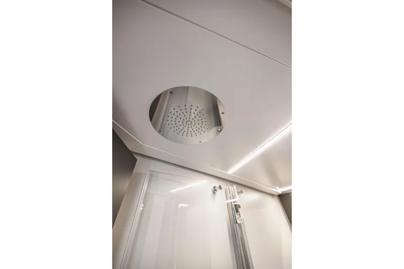 Slide: The Image of Ceiling showerhead in 2021 Pershing 62 yacht bathroom. - 119