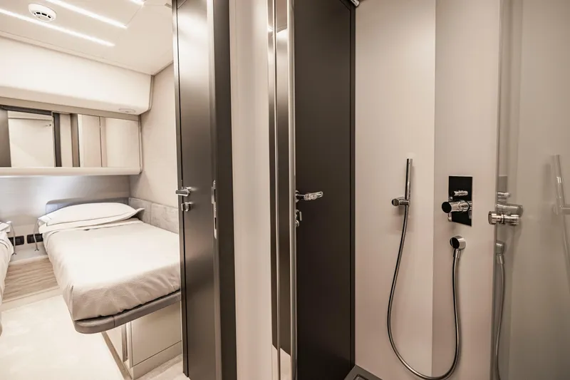 Slide: The Image of Luxurious interior of 2021 Pershing 62 yacht featuring bedroom and modern bathroom. - 120