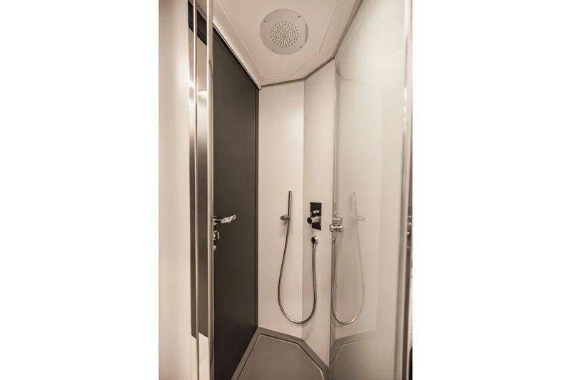 Slide: The Image of Modern shower in 2021 Pershing 62 yacht, featuring sleek design and chrome fixtures. - 121