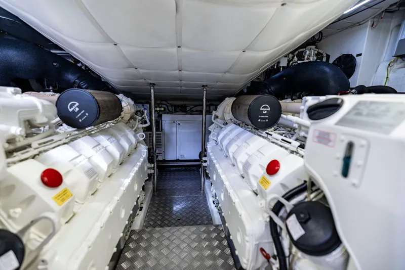 Slide: The Image of Engine room of a 2021 Pershing 62 yacht, featuring advanced machinery and equipment. - 123