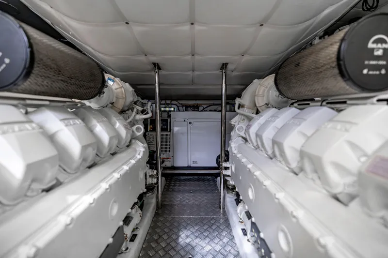 Slide: The Image of Engine room of 2021 Pershing 62 yacht, featuring dual engines and advanced machinery. - 124