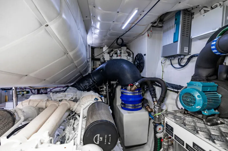 Slide: The Image of Engine room of a 2021 Pershing 62 yacht, showcasing advanced machinery and components. - 126