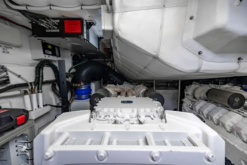 Slide: The Image of Engine room of a 2021 Pershing 62 yacht, showcasing advanced machinery and components. - 127