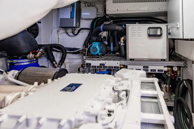 Slide: The Image of Engine room of a 2021 Pershing 62 yacht, showcasing mechanical components and systems. - 128