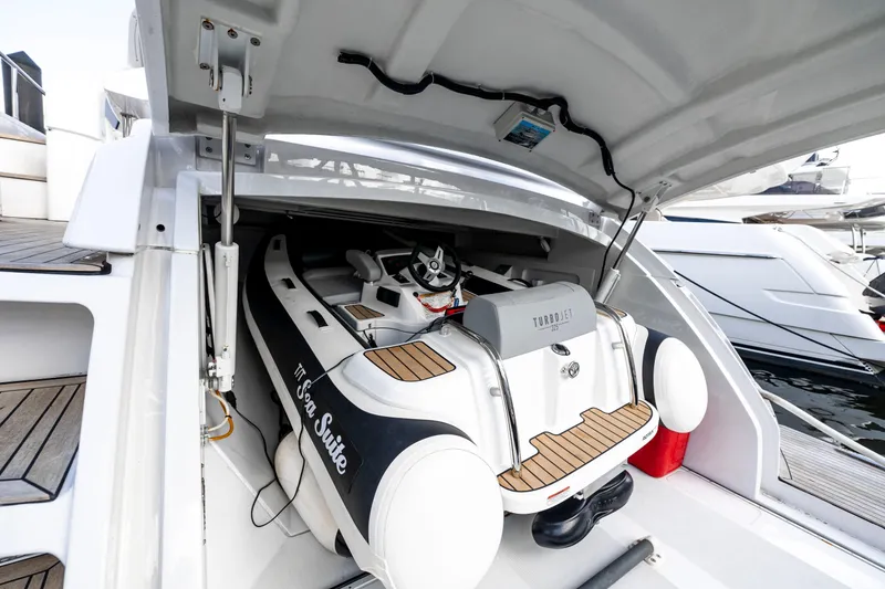 Slide: The Image of 2021 Pershing 62 yacht with Turbojet tender in storage compartment. - 132