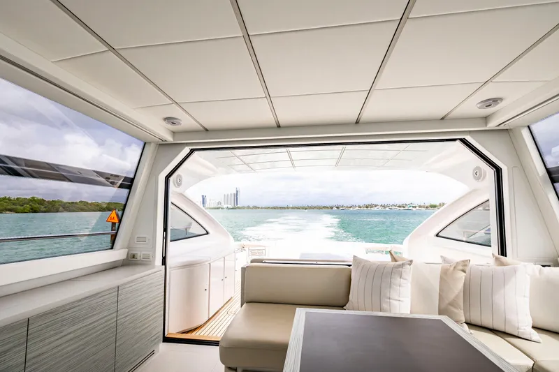 Slide: The Image of Luxurious interior of 2021 Pershing 62 yacht with ocean view through large windows. - 14