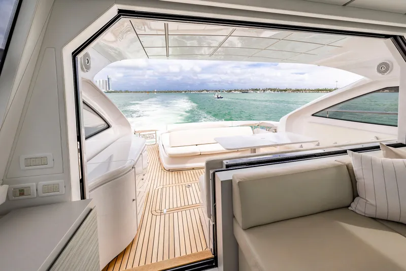 Slide: The Image of Luxurious 2021 Pershing 62 yacht interior with open deck view, cruising on serene waters. - 15