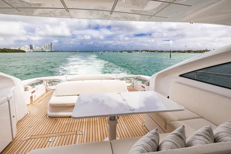 Slide: The Image of Luxurious 2021 Pershing 62 yacht cruising with city skyline and ocean view. - 16