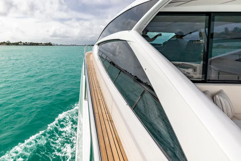 Slide: The Image of 2021 Pershing 62 yacht cruising on turquoise waters, showcasing sleek design and luxury. - 21