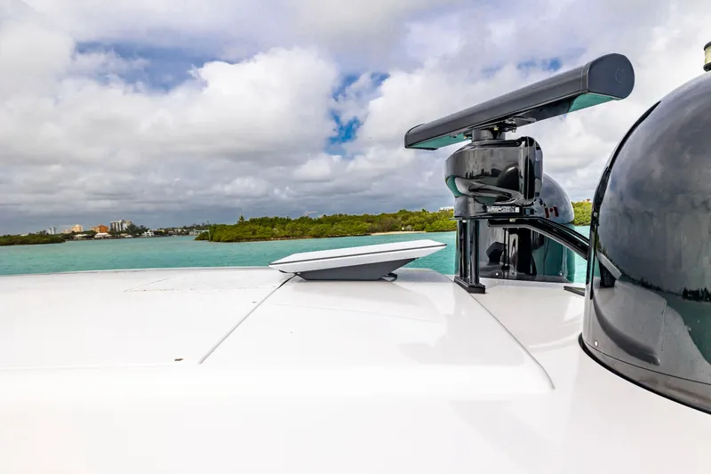 Slide: The Image of 2021 Pershing 62 yacht radar and equipment against scenic coastal backdrop. - 22