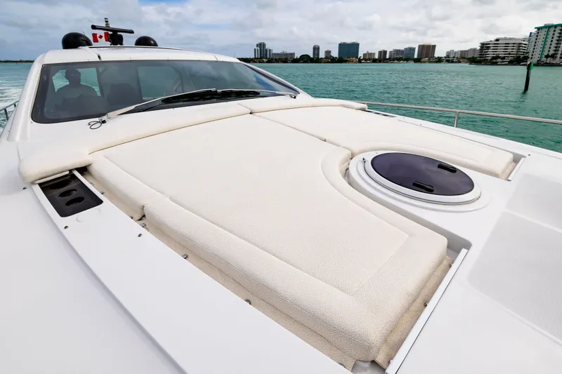 Slide: The Image of 2021 Pershing 62 yacht with sunbathing deck, cruising near city skyline. - 29