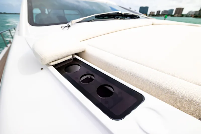 Slide: The Image of 2021 Pershing 62 yacht deck with cup holders and cushioned seating. - 30