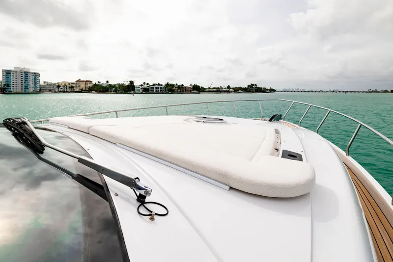 Slide: The Image of 2021 Pershing 62 yacht deck with ocean view and coastal skyline. - 31