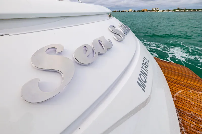 Slide: The Image of 2021 Pershing 62 yacht stern with "Sea Suite" name, wooden deck, ocean view. - 33