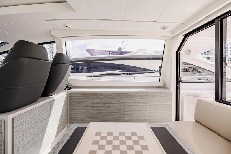 Slide: The Image of Interior of 2021 Pershing 62 yacht with modern seating and large windows. - 39