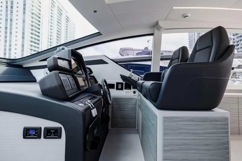 Slide: The Image of Interior of 2021 Pershing 62 yacht cockpit with modern controls and luxurious seating. - 49