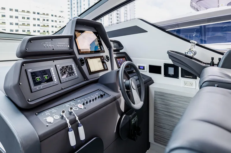 Slide: The Image of Cockpit of 2021 Pershing 62 yacht with advanced navigation controls and displays. - 50