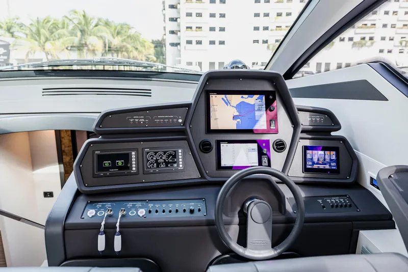 Slide: The Image of Cockpit of 2021 Pershing 62 yacht with advanced navigation displays and controls. - 51