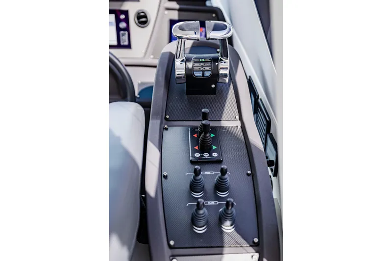 Slide: The Image of Control panel of 2021 Pershing 62 yacht with joysticks and throttle levers. - 52
