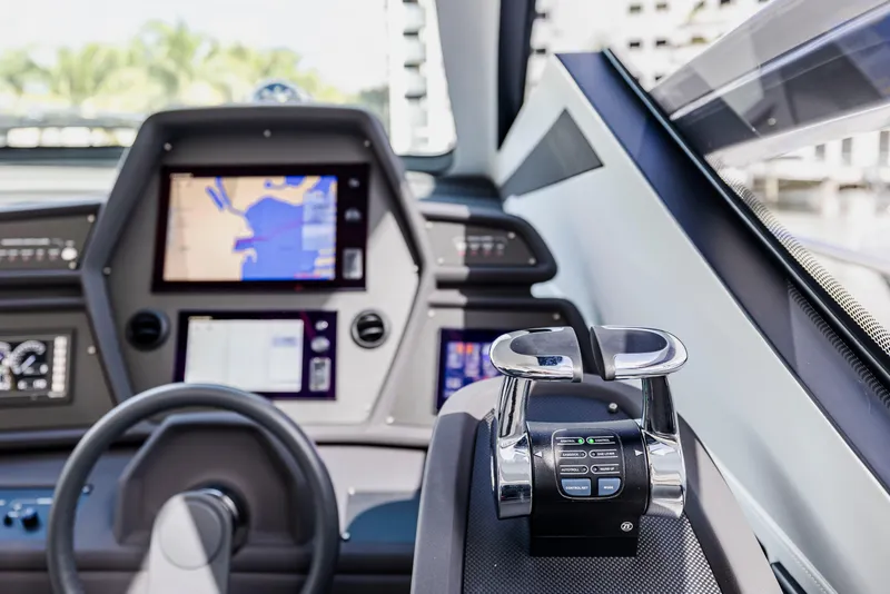 Slide: The Image of Cockpit of 2021 Pershing 62 yacht with navigation screens and controls. - 54