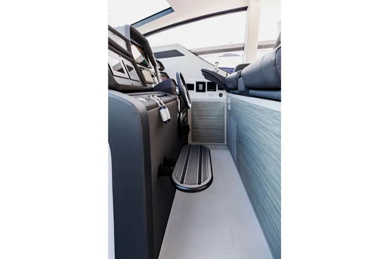 Slide: The Image of Interior of 2021 Pershing 62 yacht cockpit with modern controls and seating. - 56