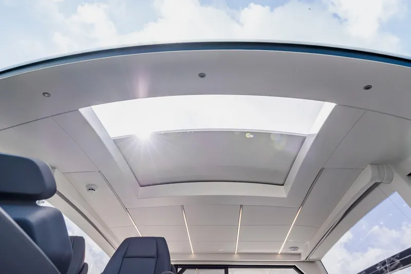 Slide: The Image of Sunroof view inside 2021 Pershing 62 yacht, showcasing sleek interior design and natural light. - 57