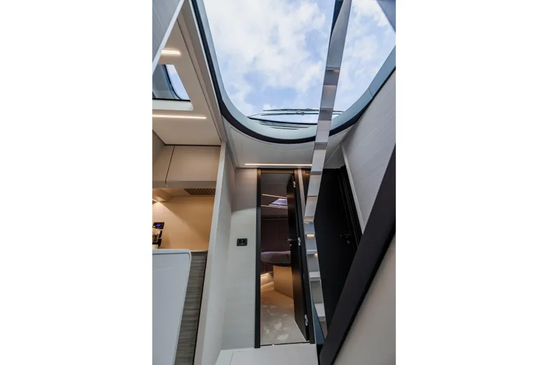 Slide: The Image of Interior view of 2021 Pershing 62 yacht with skylight and modern design. - 59