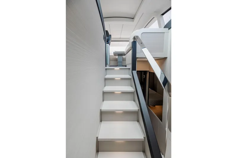 Slide: The Image of Staircase inside 2021 Pershing 62 yacht, featuring modern design and ambient lighting. - 60