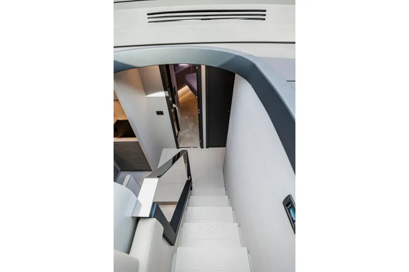 Slide: The Image of Interior staircase of 2021 Pershing 62 yacht, featuring modern design and sleek finishes. - 61