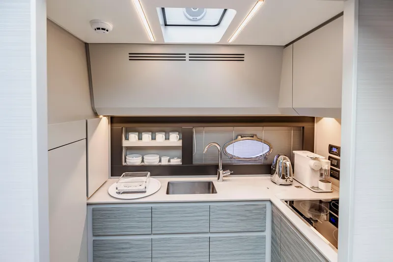 Slide: The Image of Modern kitchen interior on 2021 Pershing 62 yacht, featuring sleek cabinetry and appliances. - 64