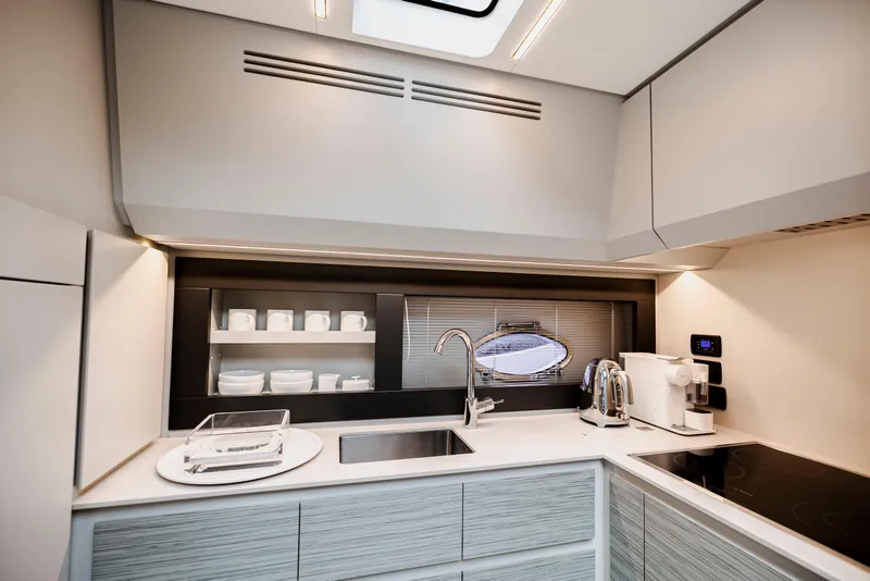 Slide: The Image of Modern kitchen interior on 2021 Pershing 62 yacht, featuring sleek design and appliances. - 69