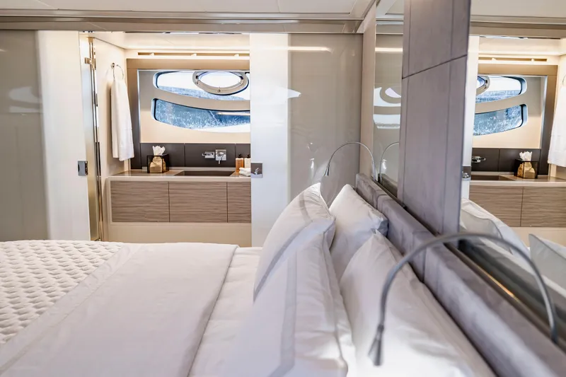 Slide: The Image of Luxurious interior of 2021 Pershing 62 yacht featuring elegant bedroom and modern bathroom. - 77