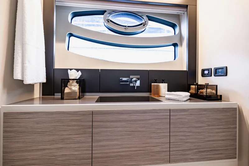 Slide: The Image of Luxurious bathroom interior of 2021 Pershing 62 yacht with modern fixtures and window. - 78