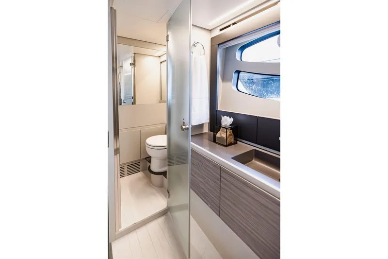 Slide: The Image of Luxurious bathroom interior of 2021 Pershing 62 yacht with modern fixtures and window view. - 79