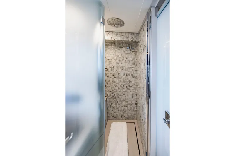 Slide: The Image of Modern bathroom interior on 2021 Pershing 62 yacht, featuring sleek design and textured walls. - 81
