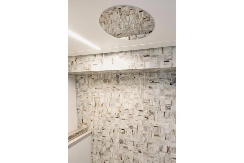 Slide: The Image of Luxurious interior of 2021 Pershing 62 yacht with elegant marble wall design. - 84