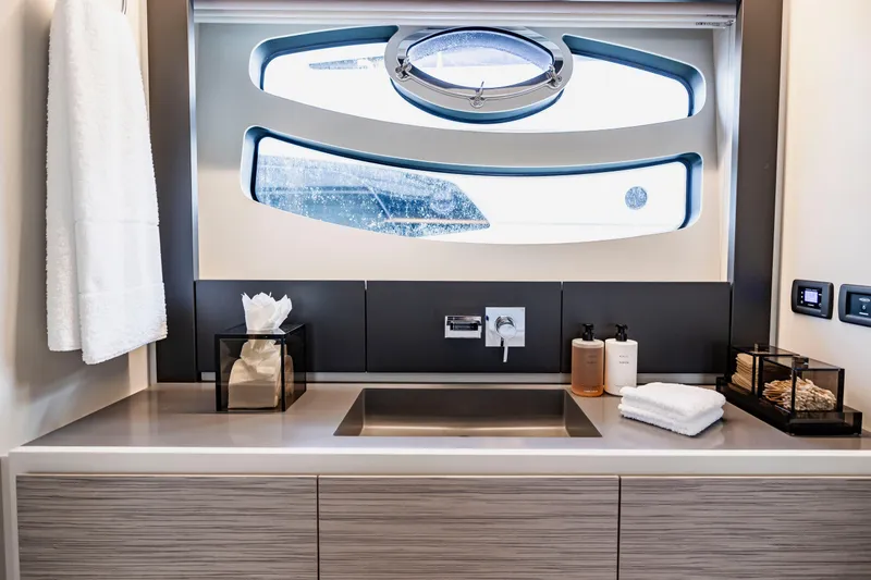 Slide: The Image of Luxurious bathroom interior of 2021 Pershing 62 yacht with modern fixtures and window view. - 86