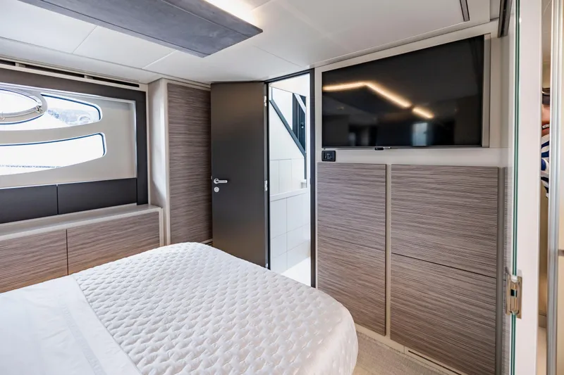 Slide: The Image of Luxurious bedroom interior of 2021 Pershing 62 yacht with modern design and TV. - 90