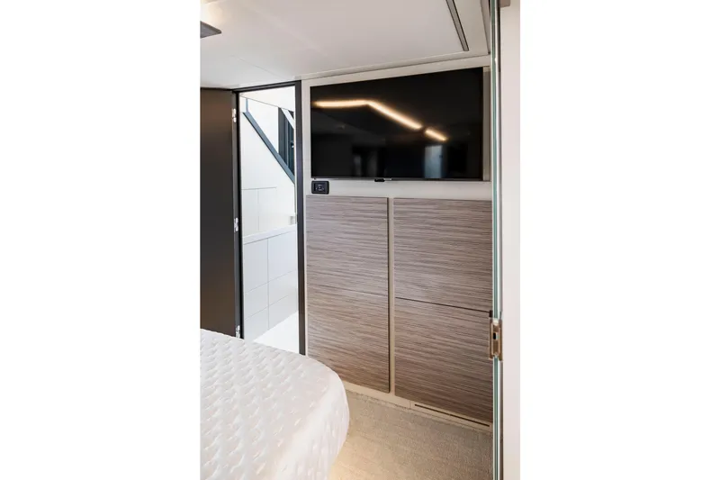 Slide: The Image of Modern interior of 2021 Pershing 62 yacht with TV and wood paneling. - 91