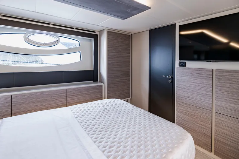Slide: The Image of Luxurious bedroom interior of 2021 Pershing 62 yacht with modern design and large window. - 92