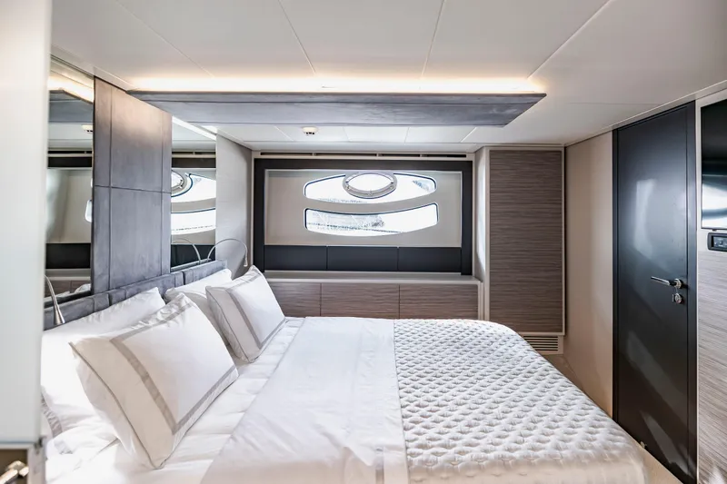 Slide: The Image of Luxurious bedroom interior of 2021 Pershing 62 yacht with modern design and elegant bedding. - 93